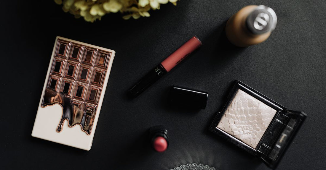 A flatlay of highlighter products including palette, liquid, and cream for a dewy look