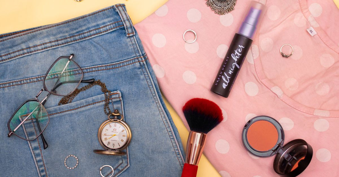A flatlay of British beauty and skincare products representing the best categories UK 2026, including serums, moisturisers, and makeup on a marble surface.