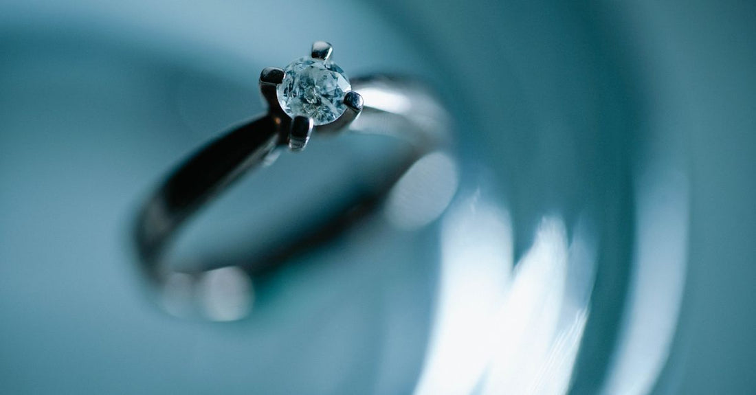 An ultrasonic cleaner filled with water and a pair of tweezers inside, demonstrating cleaning equipment for beauty tools.