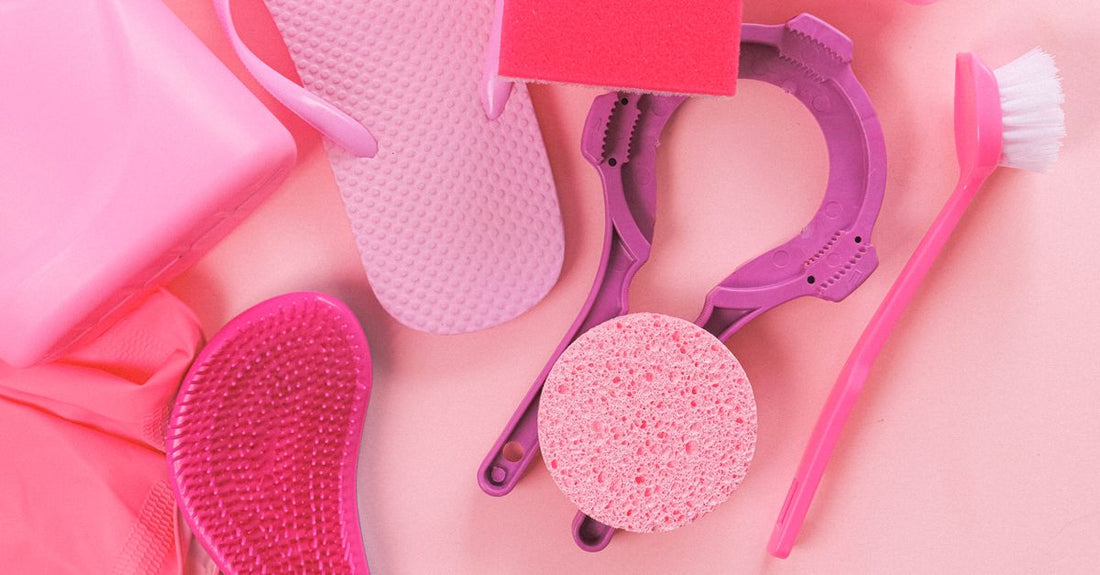 A damp pink Beauty Blender makeup sponge resting on a marble surface, demonstrating how to use a beauty blender correctly.