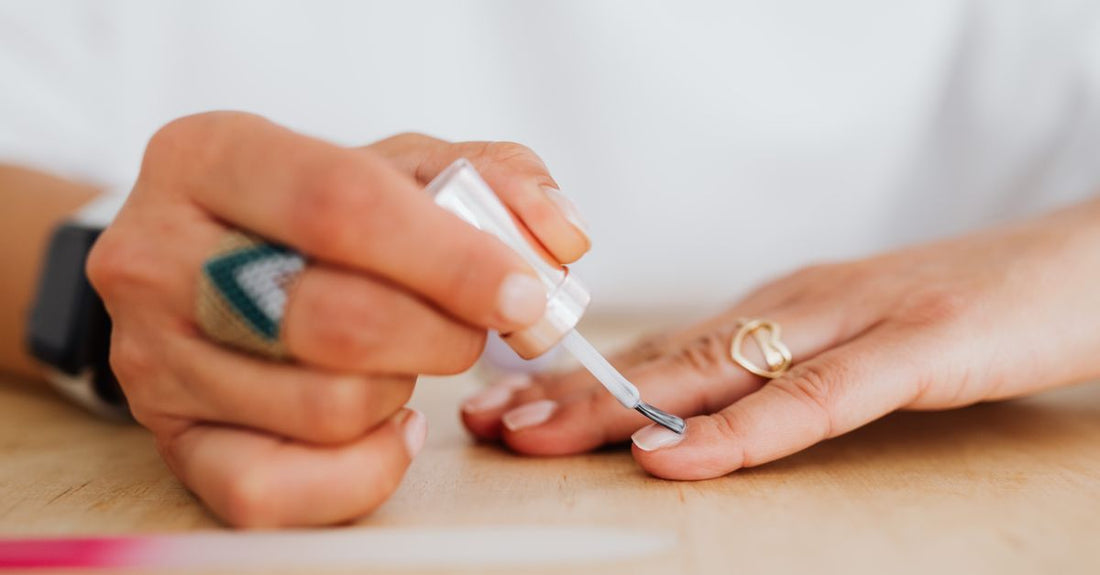 A clear base coat nail polish bottle on a white background, essential for a chip-free manicure as explained in this base coat buying guide.