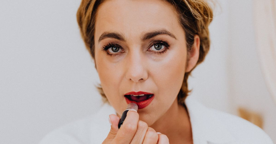 A flatlay of three lipstick tubes in pink, red, and nude shades with a matte texture, representing the best lipstick 2026 options.