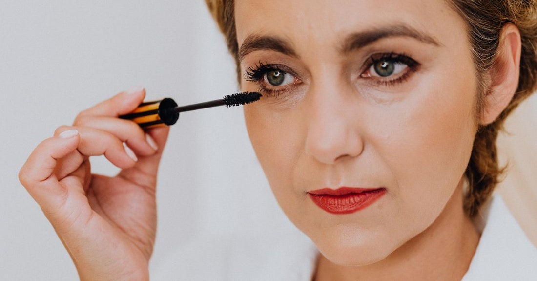 A sleek white tube of eyelash primer on a clean white background, illustrating how to choose eyelash primers correctly.