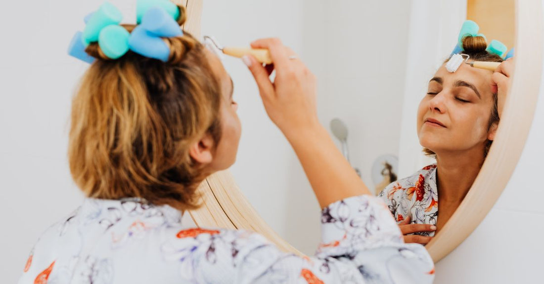 A set of ceramic hair rollers on a vanity table, demonstrating how to use hair curler without damage.