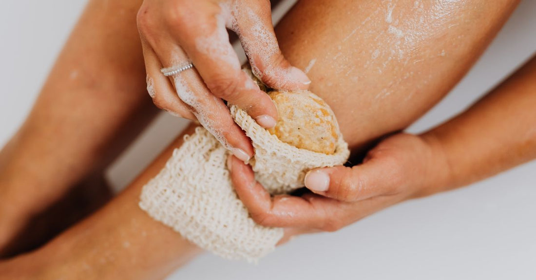A selection of exfoliating bath sponges in a flatlay, showing different textures and colours, for the bath sponges buying guide.