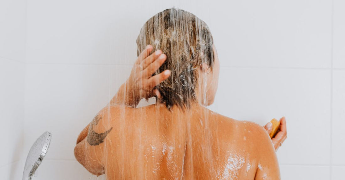 A selection of back acne treatment products including body washes and sprays on a clean bathroom shelf, illustrating how to get rid of back acne effectively.