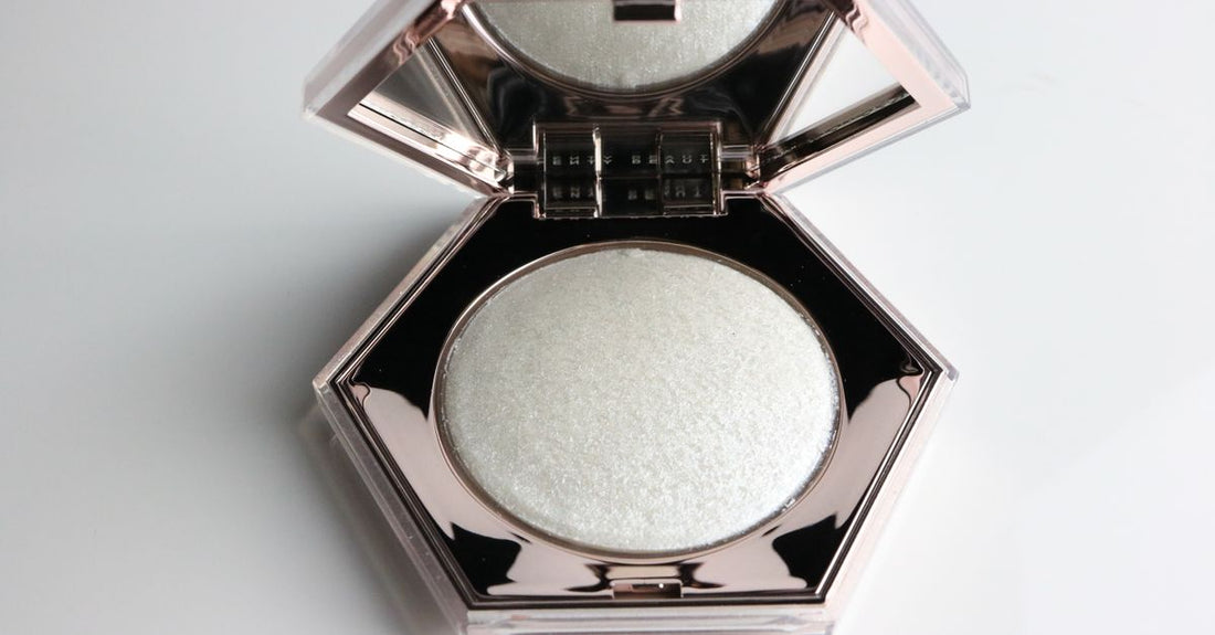 A close-up flatlay of a pressed bronzer compact with a velvety texture, showing a warm terracotta shade — how to choose bronzers for a natural glow.