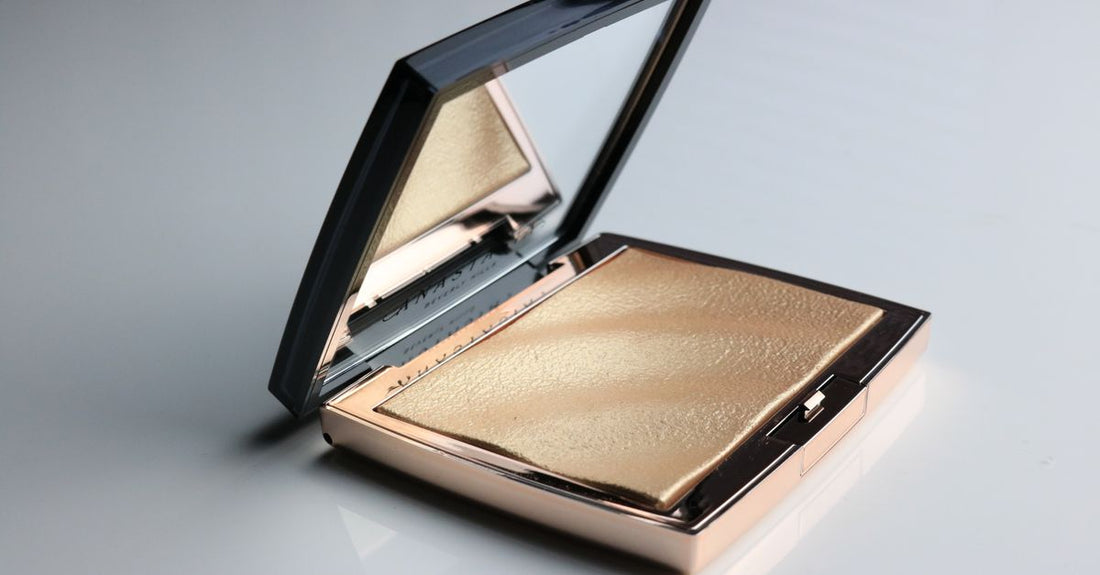 Bronzers buying guide featuring a flatlay of bronzer compacts and brushes on a marble surface.
