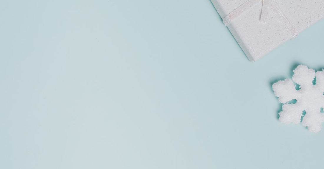 A flat lay of a skincare gift set featuring a cleanser, moisturiser, and serum on a marble surface, illustrating what to look for in a skincare gift set.