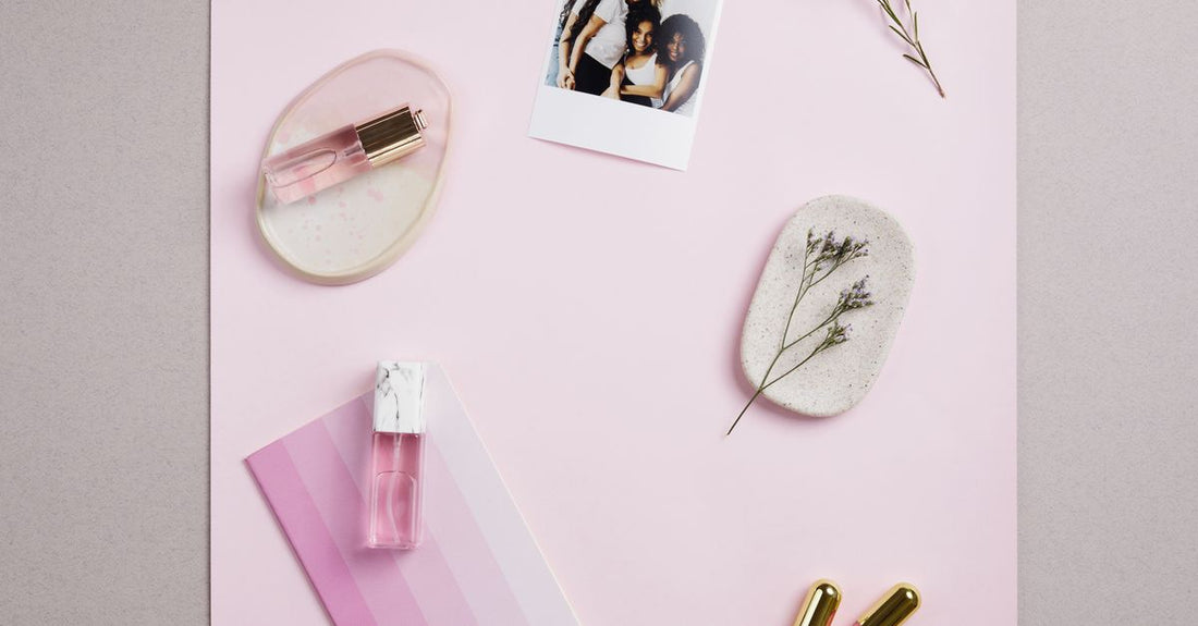 A flatlay of the best styling products UK 2026, including styling cream, texture powder, and curl cream on a bathroom shelf.