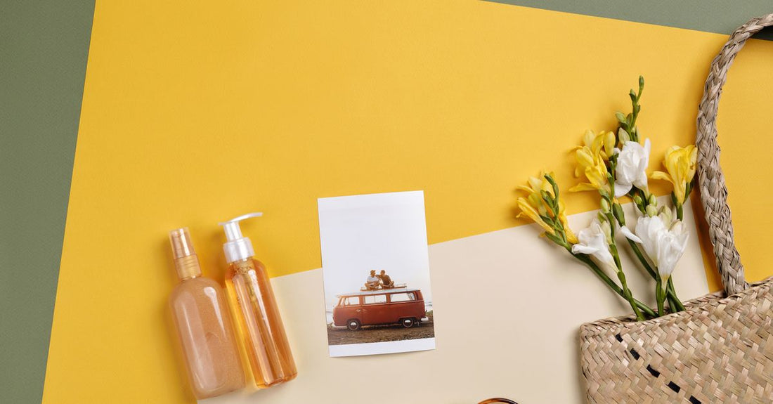 A selection of best body sprays UK 2026 arranged on a marble surface with botanical accents.