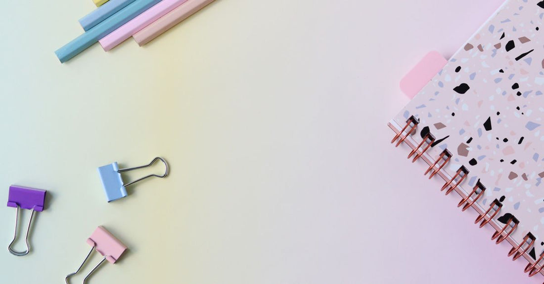 A selection of colourful flat duckbill hair clips arranged on a surface, showing how to choose clips without damaging hair.