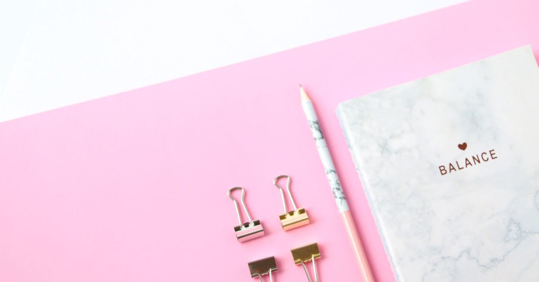 Assorted hair clips including claw clips, snap clips, and barrettes arranged on a marble surface, illustrating how to choose clips for damage-free styling.