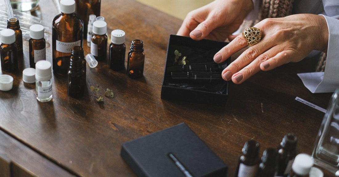 A flatlay of different cologne bottles on a marble surface, illustrating a cologne buying guide