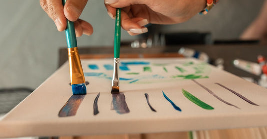 A selection of professional nail art brushes arranged on a white surface, showing different shapes and sizes for how to choose nail art brushes.