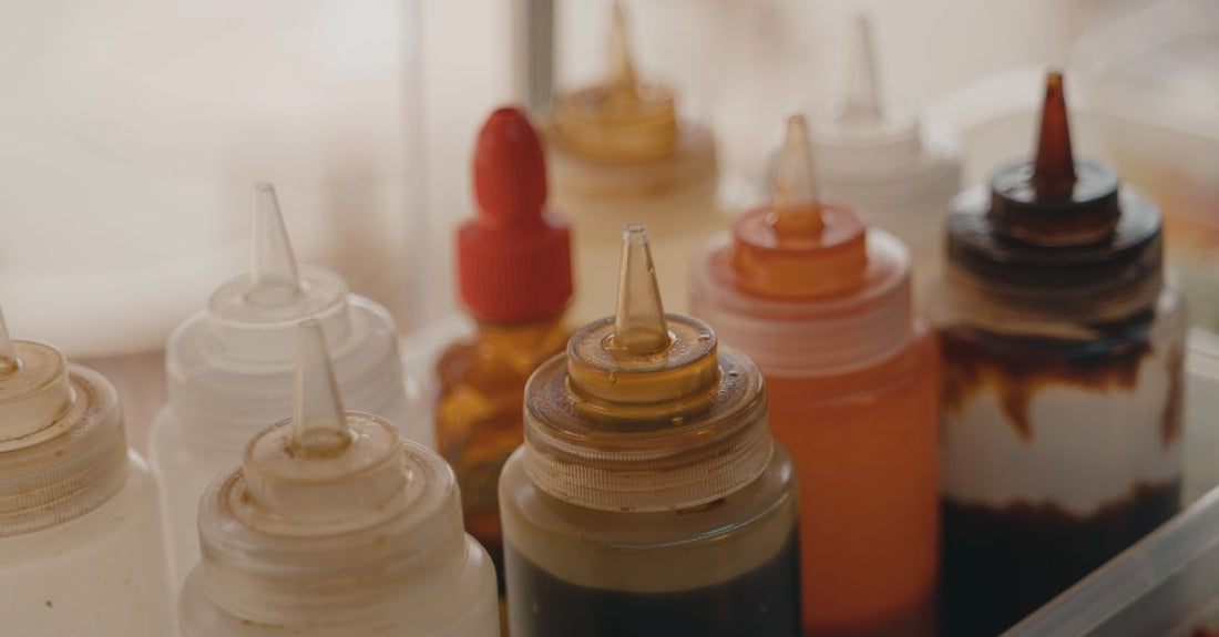 Collection of best hair treatment oils 2026 bottles on a bathroom shelf, including argan, rosemary, and ayurvedic oils.