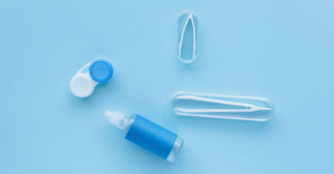 A flatlay of various beauty adhesive bottles and tubes on a white surface, illustrating an adhesives buying guide UK.