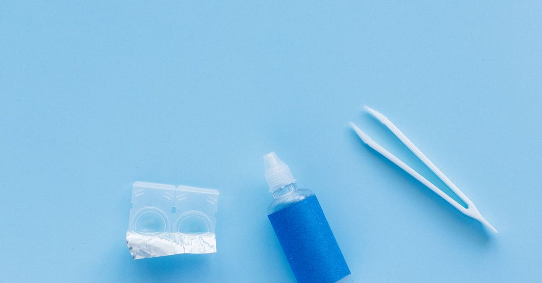 A flatlay of best adhesives 2026 bottles and tubes on a clean surface, showcasing professional hair and skin bonding products.