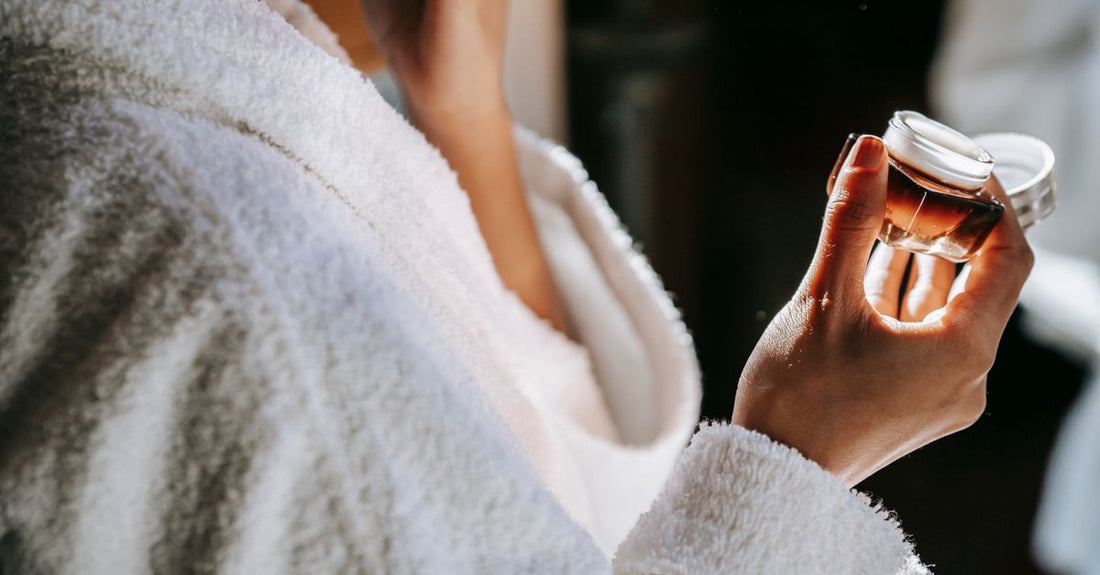 A sleek white moisturiser jar on a marble surface, representing the best creams 2026 for long-term skin health.