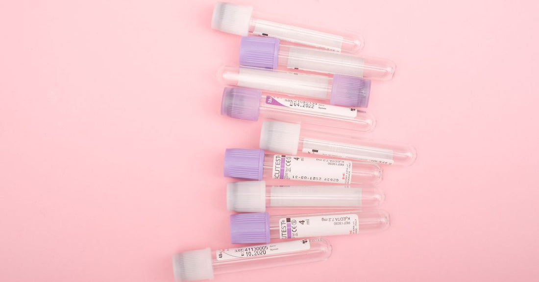 A flatlay of moisturiser jars and lip balm tubes on a light marble surface, illustrating a balms & moisturisers buying guide for UK shoppers.