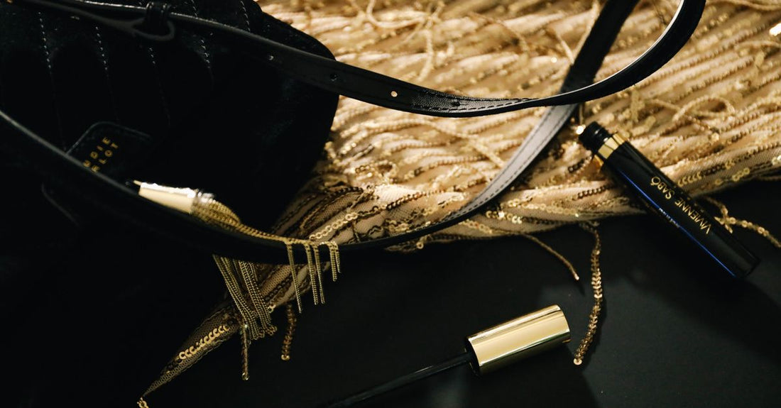 Best mascara for length and volume UK displayed in a clean flatlay with black mascara tubes and wands on a marble surface.