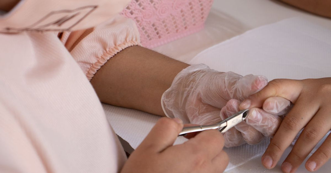 A pair of curved stainless steel cuticle scissors on a white background, demonstrating how to choose cuticle scissors UK