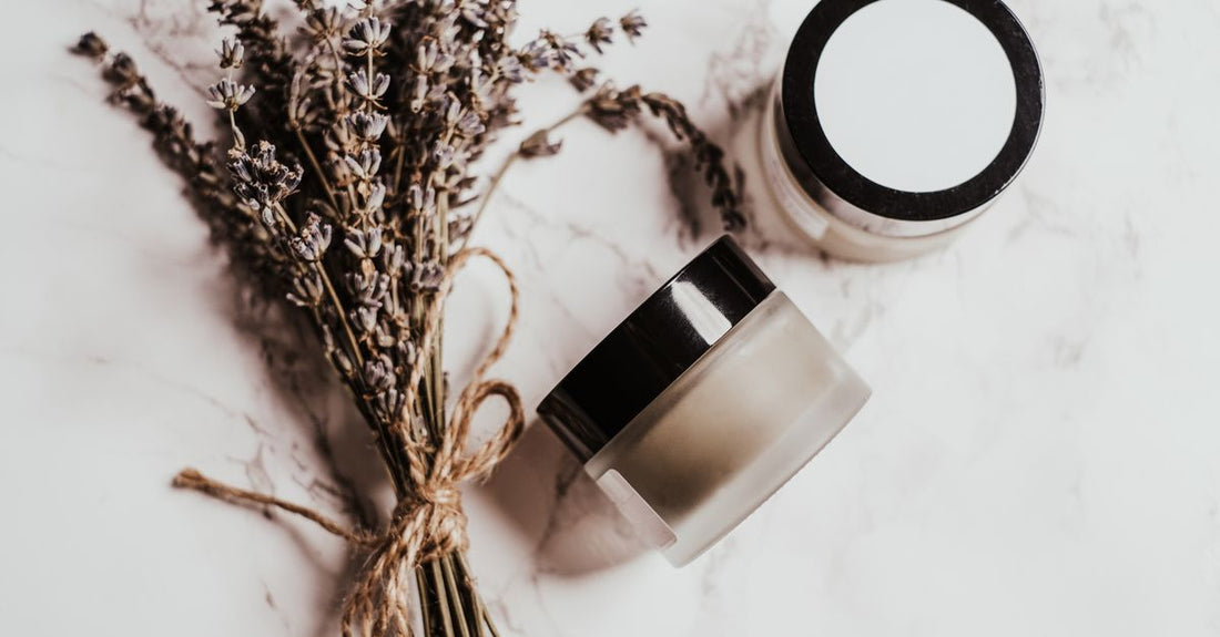 A jar of best sleeping mask for dry skin uk resting on a clean surface with moisturising ingredients beside it