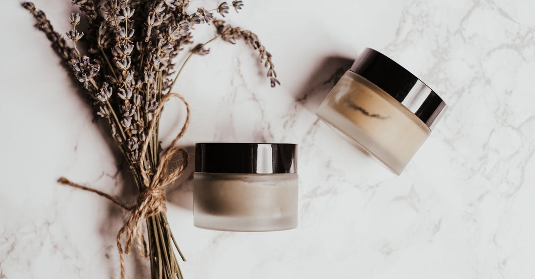 Selection of the best clays UK 2026 in white jars on a clean surface, representing value clay masks for different skin types.