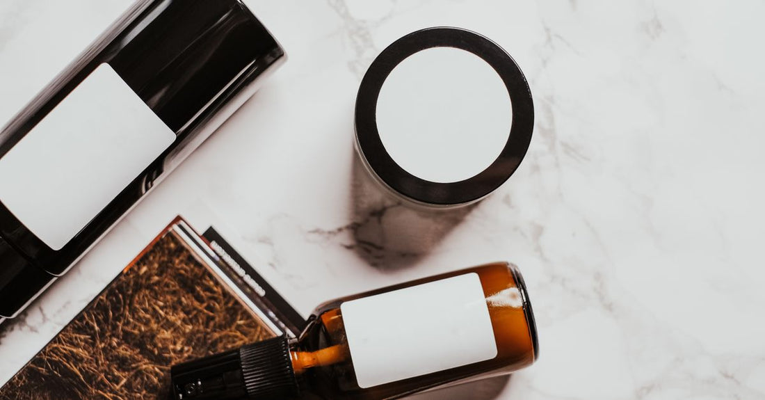 Facial self tanners buying guide UK featuring a bottle of self tan on a marble surface