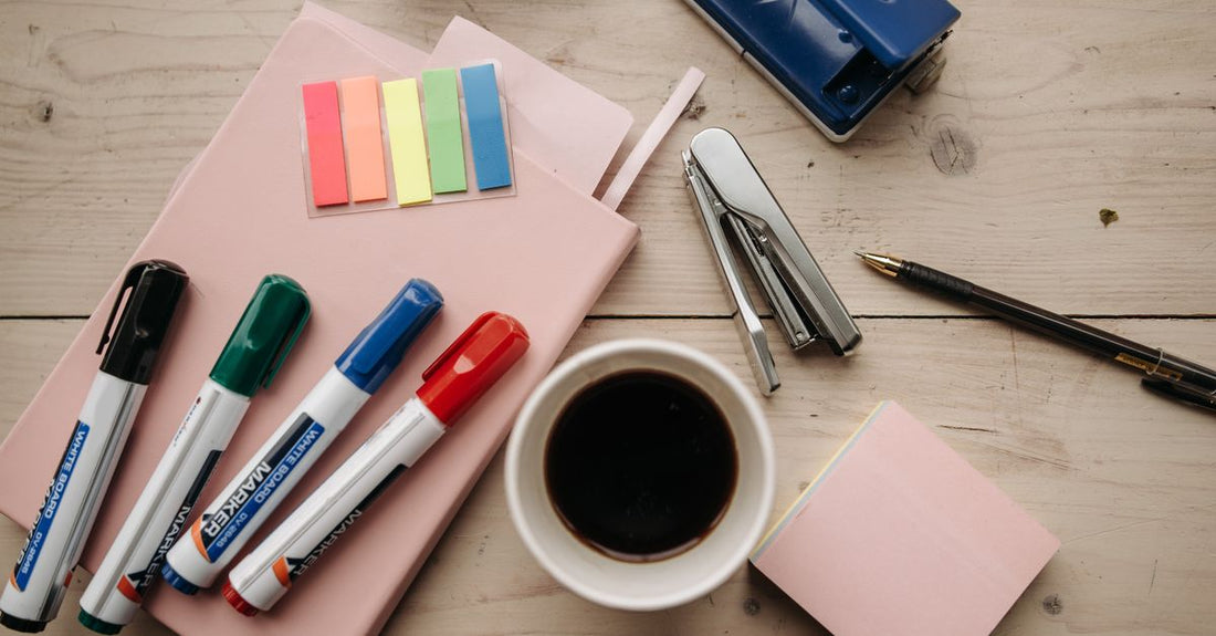 A flatlay of various eyeliner products including pens, gels, and pencils on a marble surface, showing different tip shapes and finishes.