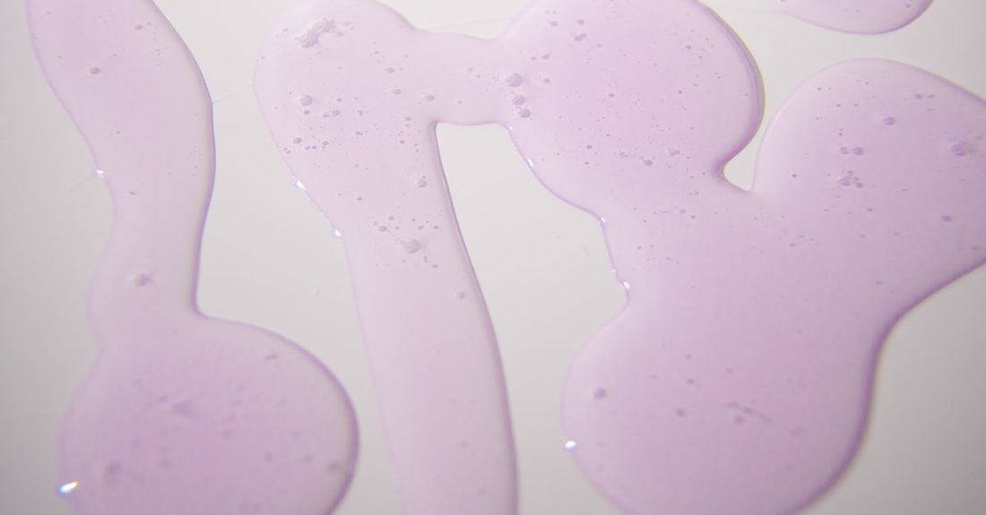 A pair of moisturizing gel socks on a clean white surface next to a foot cream tube, illustrating a moisturizing socks buying guide UK