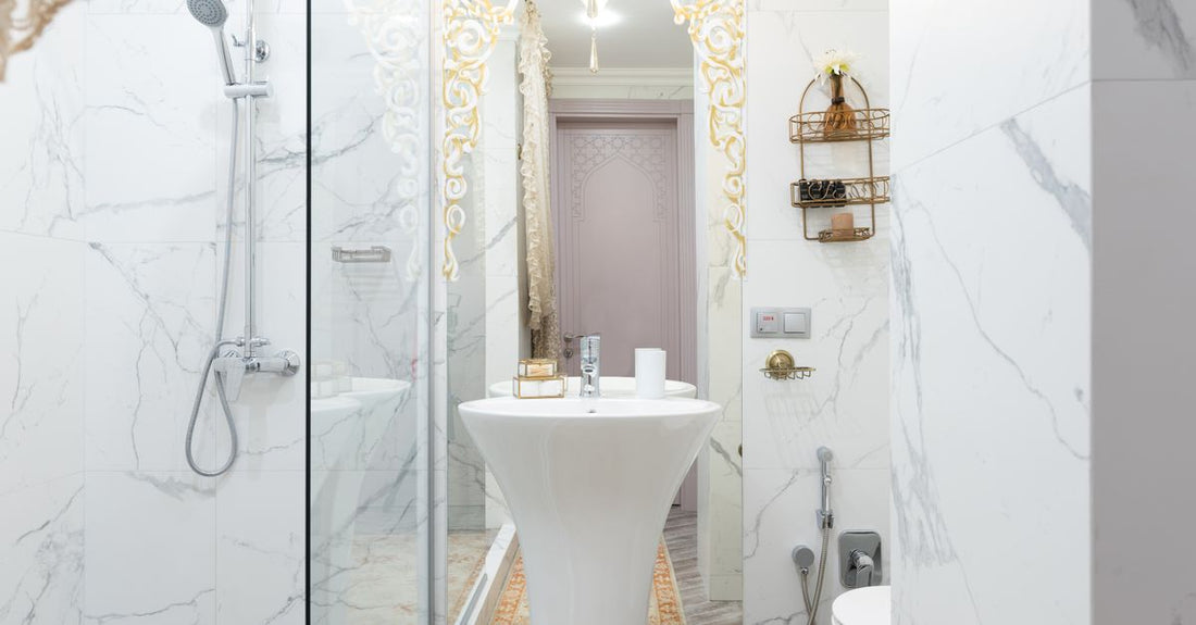 A selection of the best body washes 2026 displayed on a cool marble surface, perfect for refreshing UK summer skin.