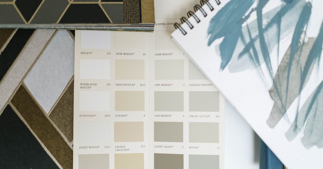 An array of professional hair colour bottles and swatches laid out on a white surface, illustrating how to choose hair colour.