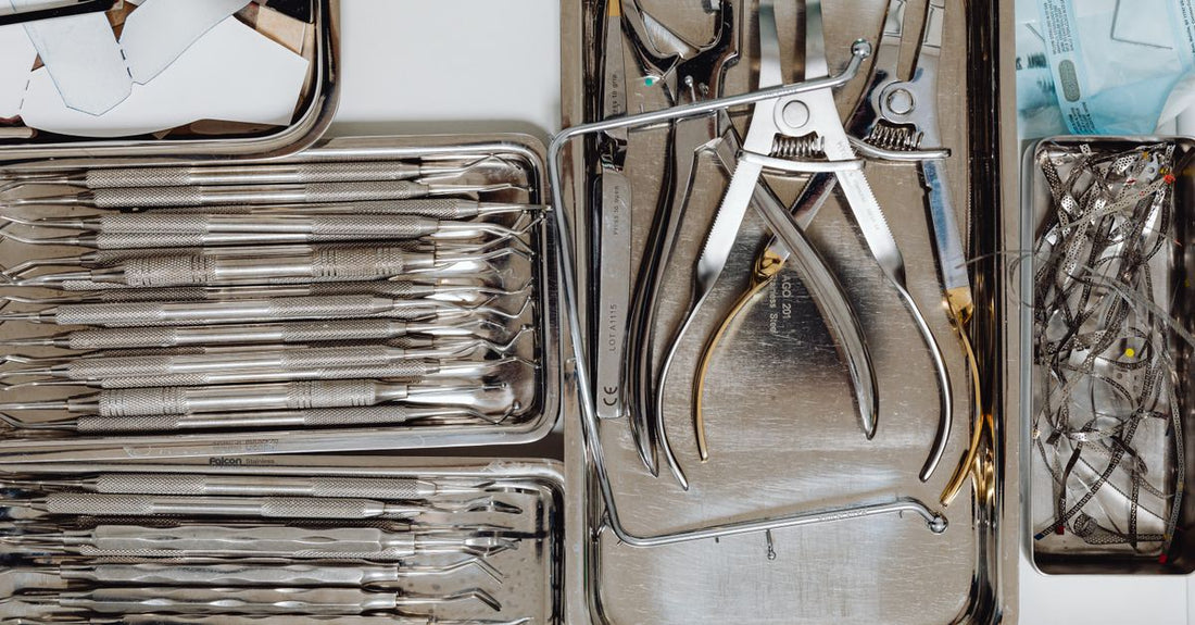 A flatlay of stainless steel blackhead and blemish remover tools showcasing different loop shapes for safe pore extraction