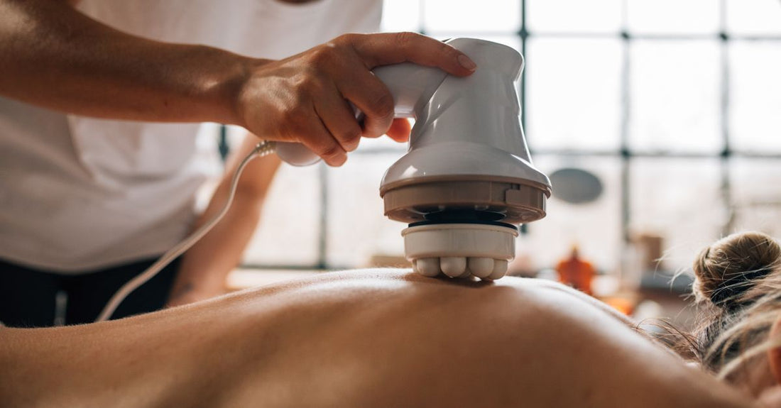 A sleek handheld cellulite massager device on a clean white surface, representing the best cellulite massagers 2026 guide by Avelisse.