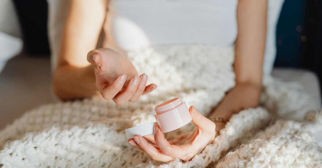 A selection of the best night creams UK 2026, showing jars with skincare ingredients on a minimalist surface.