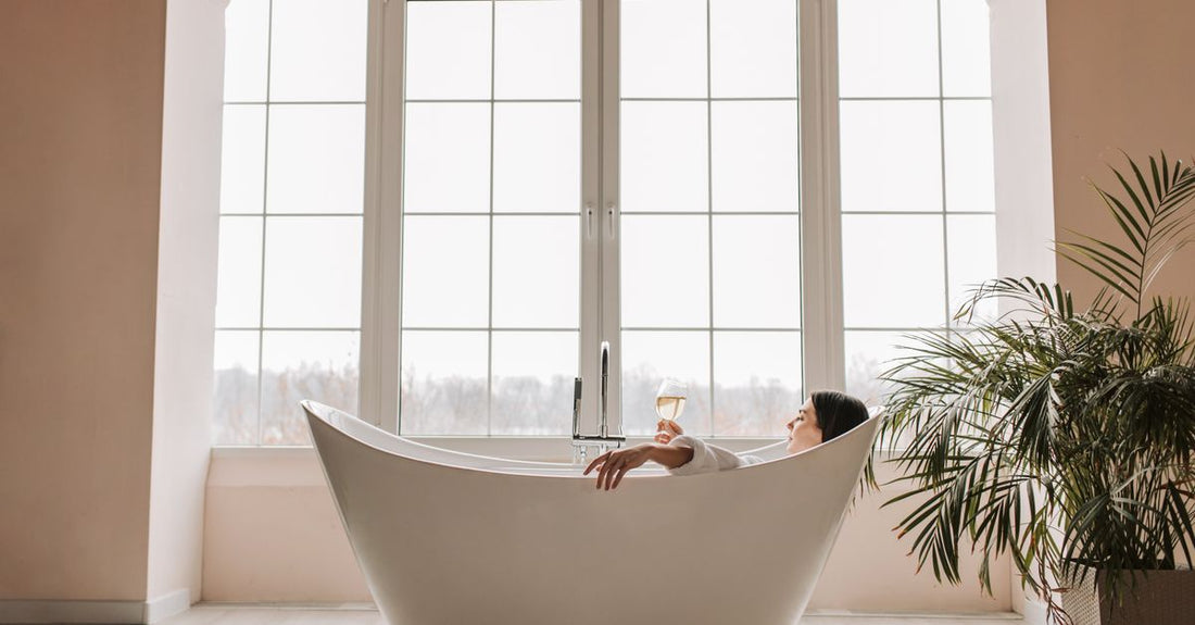 A white 4D air mesh bath pillow resting on a modern white bathtub edge, showing how to choose bath pillows for UK homes.