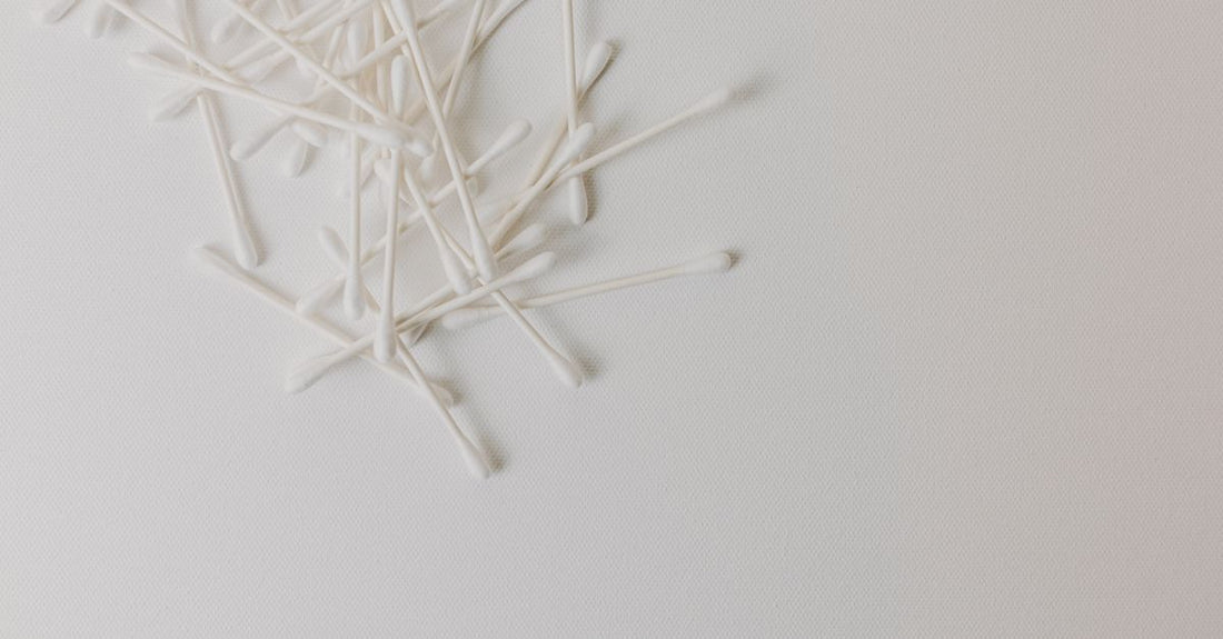 A selection of precision cotton swabs arranged on a clean surface, showcasing different tip shapes for beauty routines.