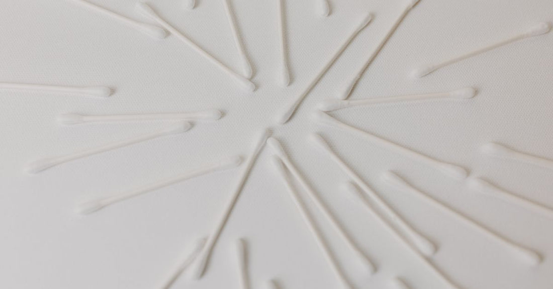A row of antiperspirant deodorant sticks and roll-ons on a clean white background, illustrating how to choose antiperspirant deodorant wisely.