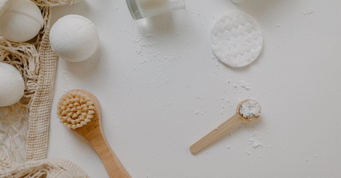An assortment of colourful handmade bath bombs arranged on a wooden surface, illustrating a bath bombs buying guide for UK shoppers.