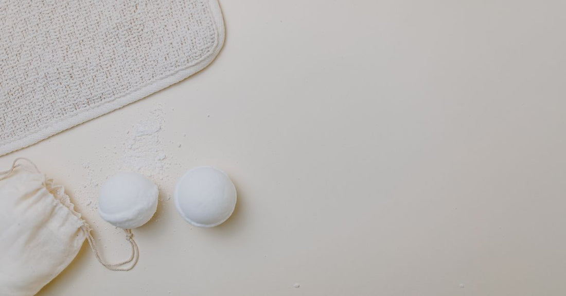 A selection of colourful bath bombs arranged on a neutral background, illustrating how to use bath bombs safely.