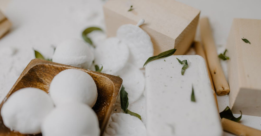 A flatlay of colourful handmade bath bombs on a white marble surface, illustrating how to choose bath bombs for a luxurious soak.