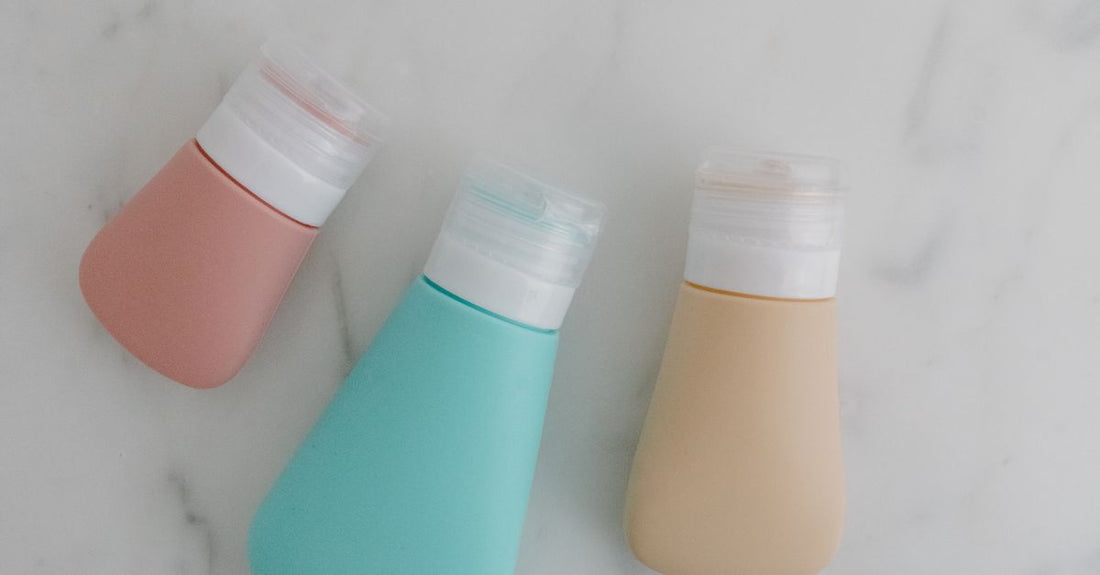 A lineup of diverse shampoo and conditioner bottles on a clean surface, illustrating a hair care buying guide UK comparison.