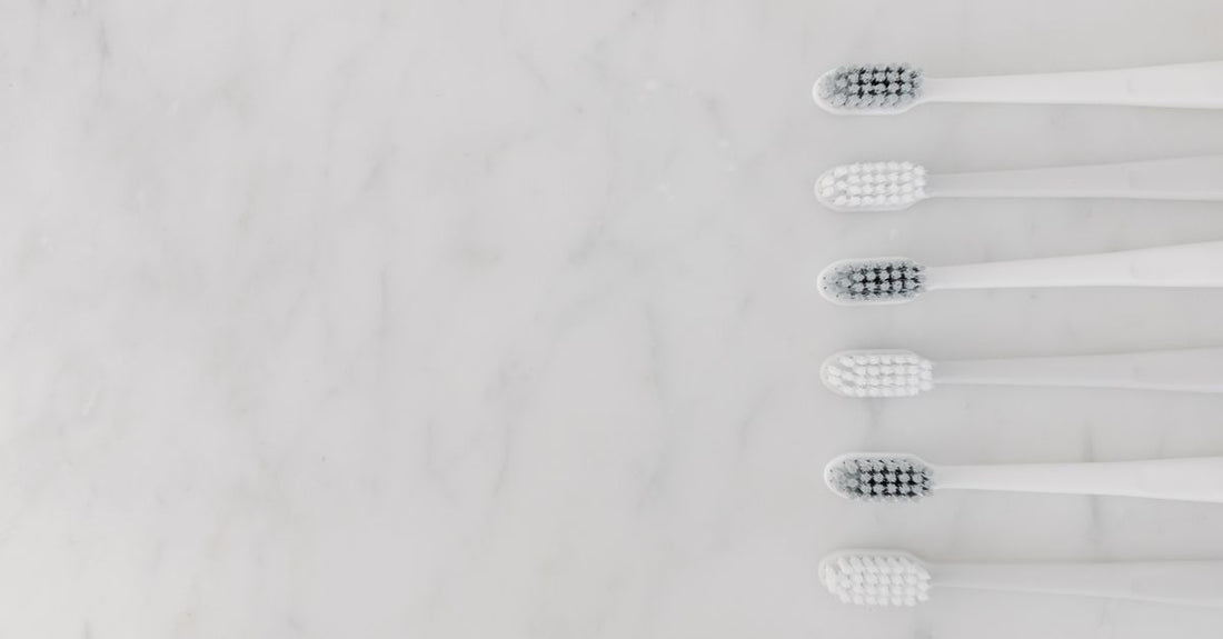 A flatlay of various wooden hair brushes with boar bristles, part of a hair brushes buying guide.