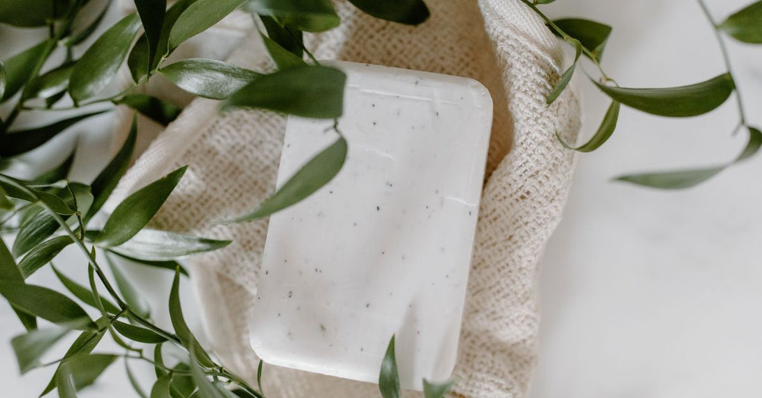 A flatlay of three different cleansing bars on a light marble surface, used to illustrate how to choose bars for UK skincare beginners.