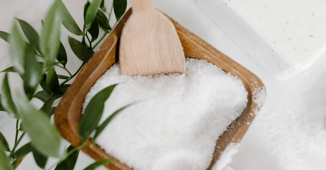 Bowl of best bath salts for muscle relaxation UK, with lavender and Epsom salt crystals on a spa shelf