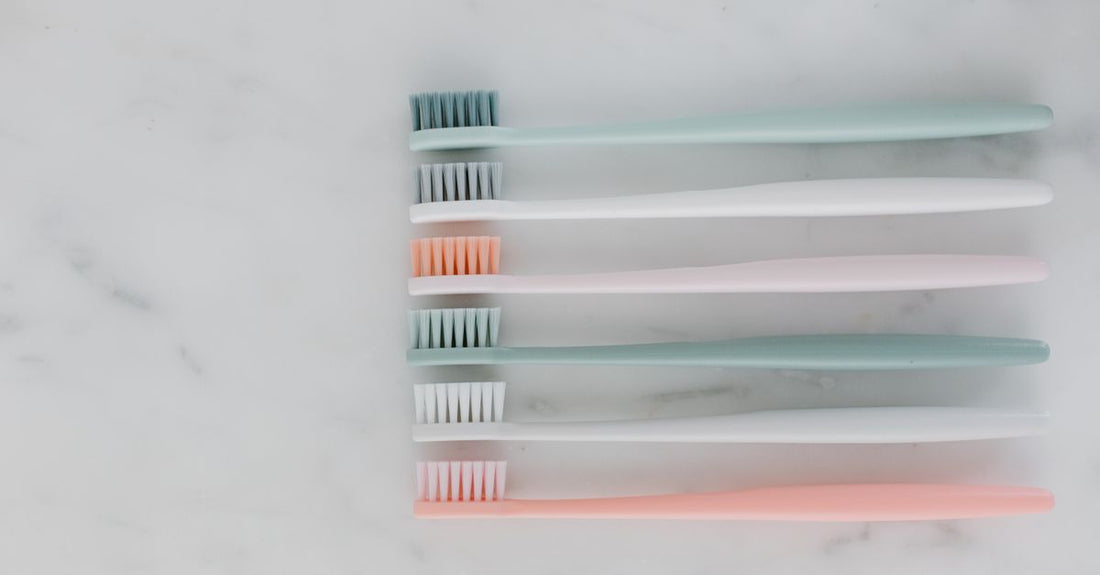 A selection of the best hair brushes 2026 laid out on a marble surface, showcasing different bristle types and handle designs.