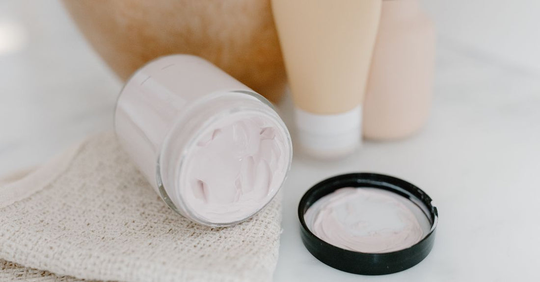 An assortment of night cream jars photographed flatlay on a marble surface, illustrating a night creams buying guide UK.