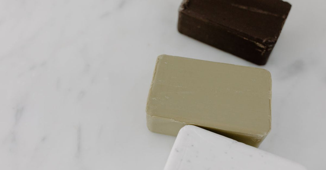 Assorted natural soap bars on a marble surface, representing the best bars UK 2026 for skincare.