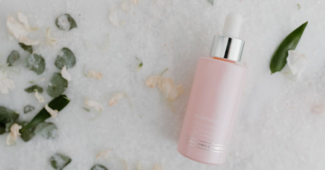 Scalp serum bottle on marble surface next to a dropper, illustrating how to choose growth formula UK products for a complete morning-to-night routine.